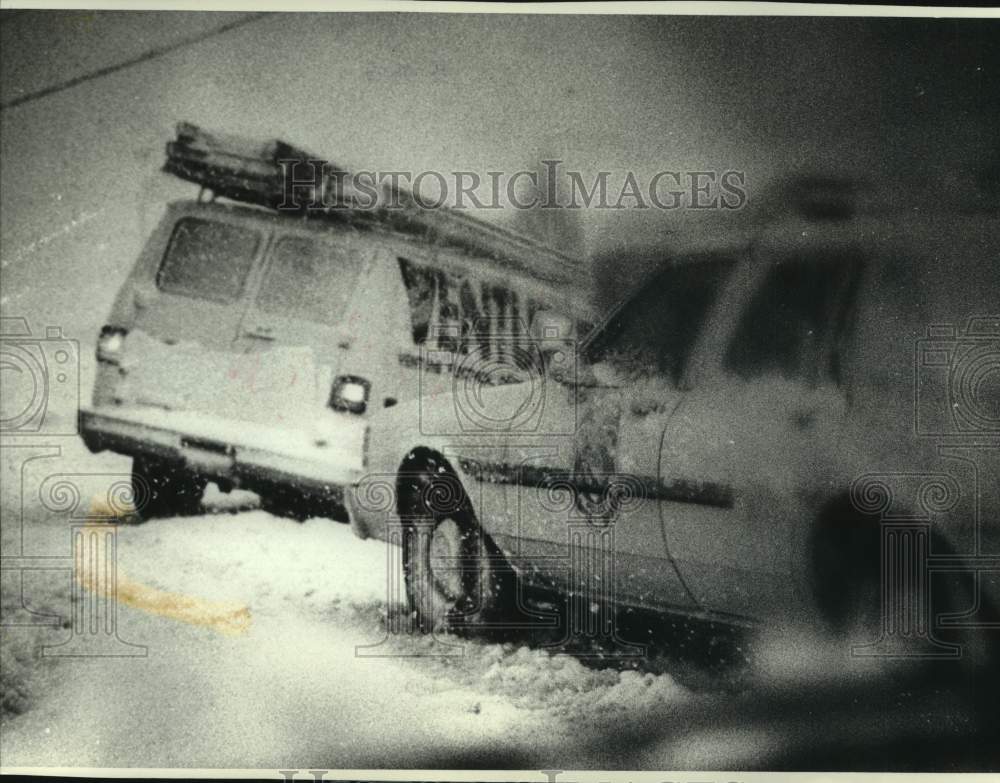 1990 Press Photo Police help resident who crashed during snowstorm in Milwaukee- Historic Images