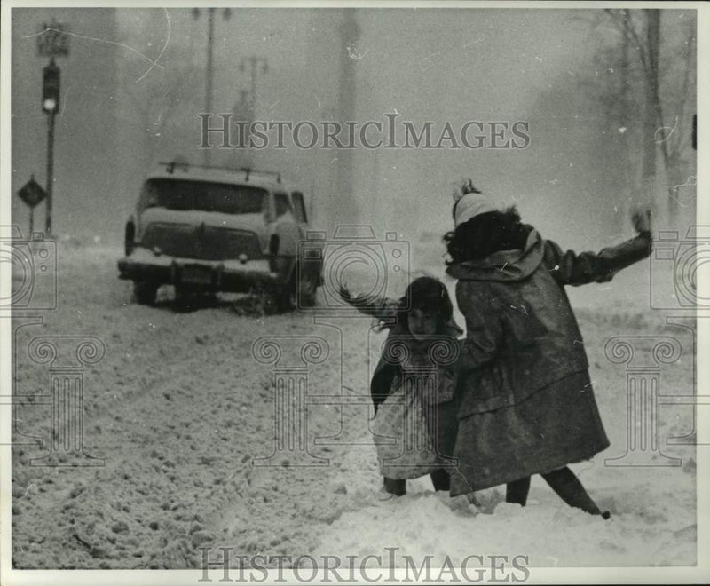 Load image into Gallery viewer, 1960 Press Photo Girls slip in heavy snow brought by storm in Milwaukee
