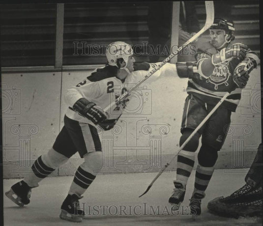 1985 Press Photo Admiral's Darrell Anholt (L) swings at Peoria's Dave MacQueen.- Historic Images