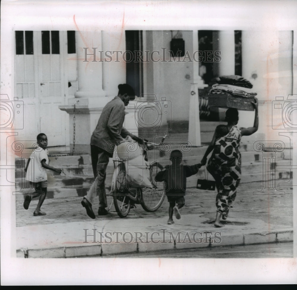 1961 Press Photo Family hurried away from fighting troops in Zaire - mjw05842- Historic Images