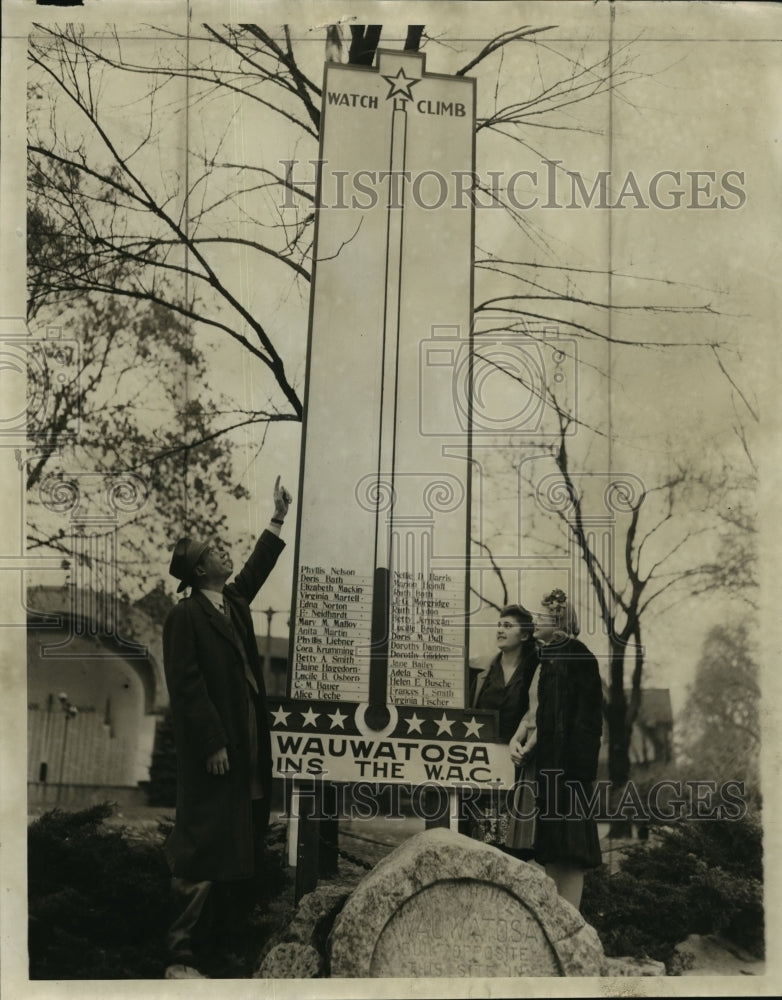 1943 Press Photo George Hunt and others looking up at a thermometer in Wauwatosa