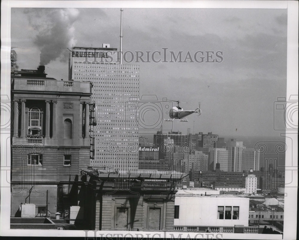 1956 Press Photo Helicopter hovers over helipad on Chicago, Illinois rooftop