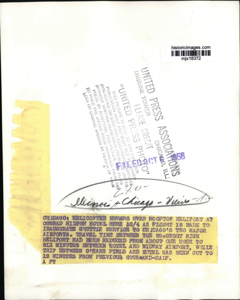 1956 Press Photo Helicopter hovers over helipad on Chicago, Illinois rooftop