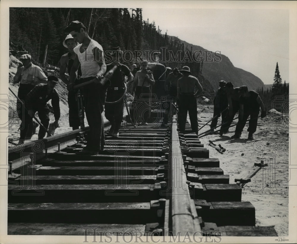 1953 Press Photo Laying down train tracks on mile 37 in Canada- Historic Images