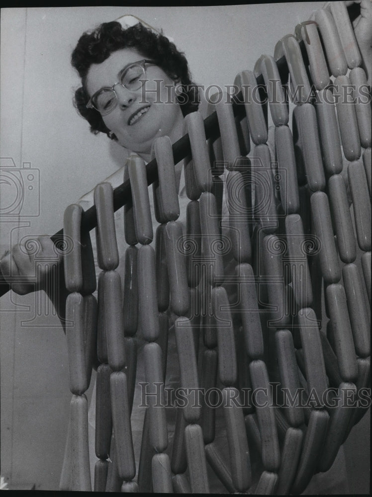 1956 Press Photo Mrs. Flek Nagy held stick of wieners in Cudahy's meat plant