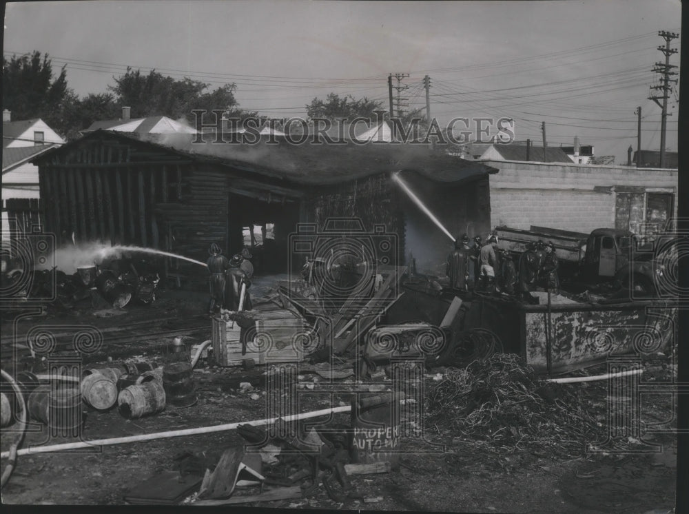 1954 Press Photo Firemen Soak a Charred Building After Explosion in Milwaukee