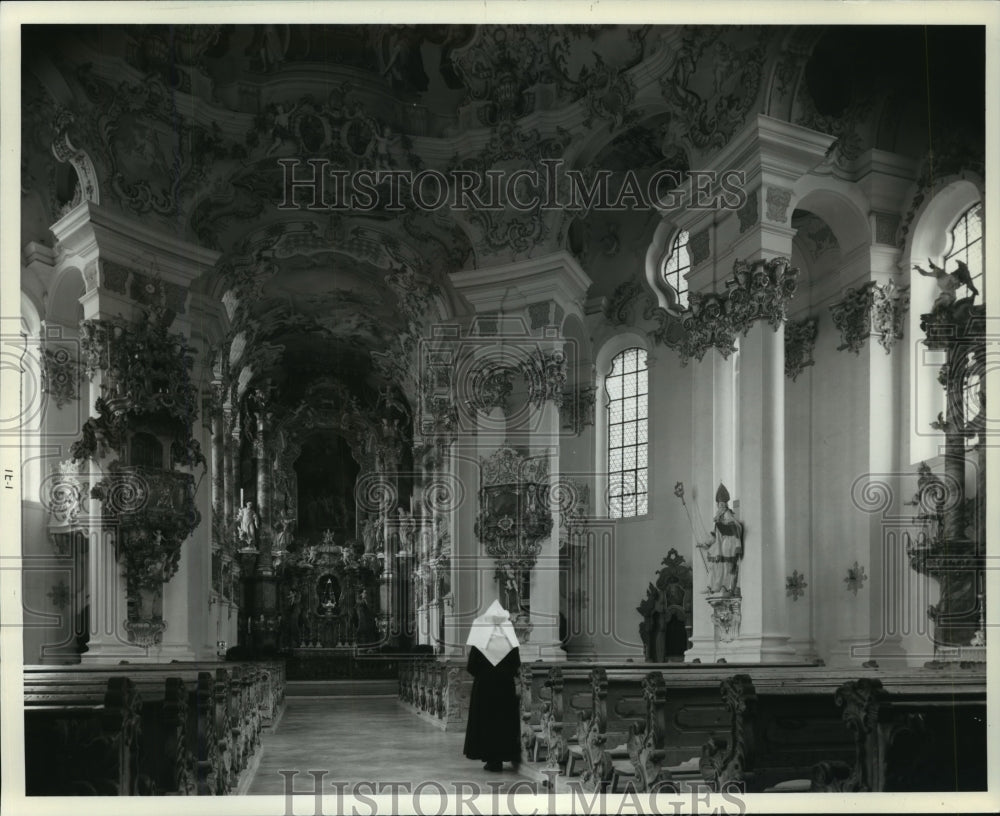 1983 Press Photo Nun standing near pews in an empty church - mjx32012- Historic Images