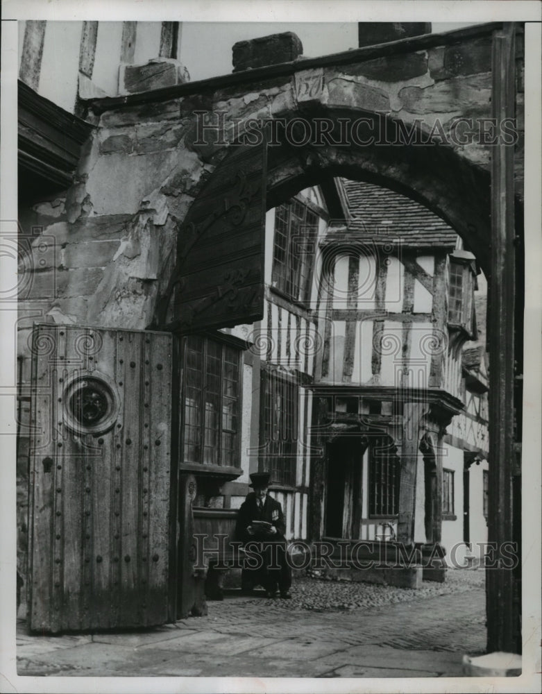 1951 Press Photo Old Soldier reads outside the old Earl of Leicester Hospital