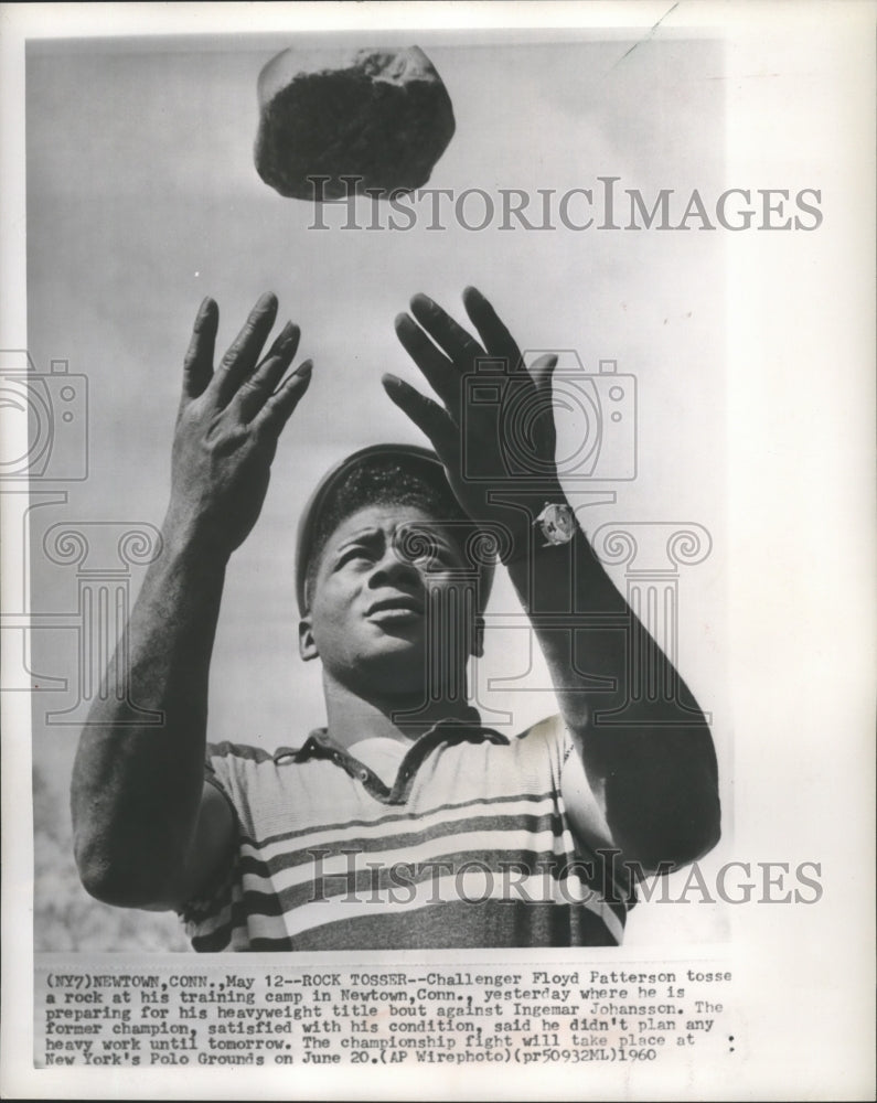 1960 Press Photo Boxer Floyd Patterson tosses a rock as part of training- Historic Images