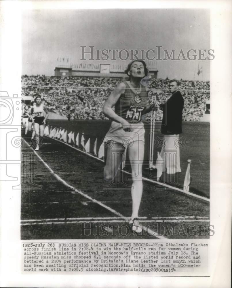 1954 Press Photo Russian distance runner, Nina Otkalenko crosses finish line- Historic Images