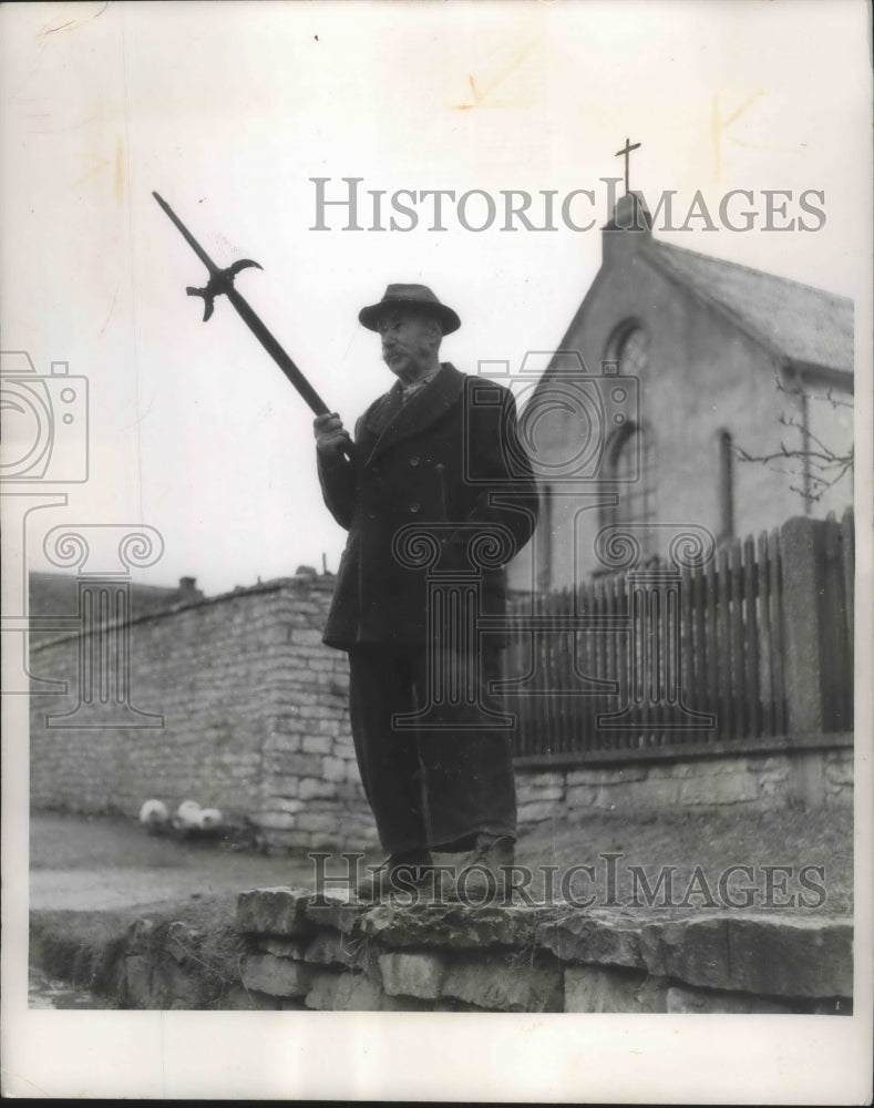Press Photo German villager standing watch while folks are in church