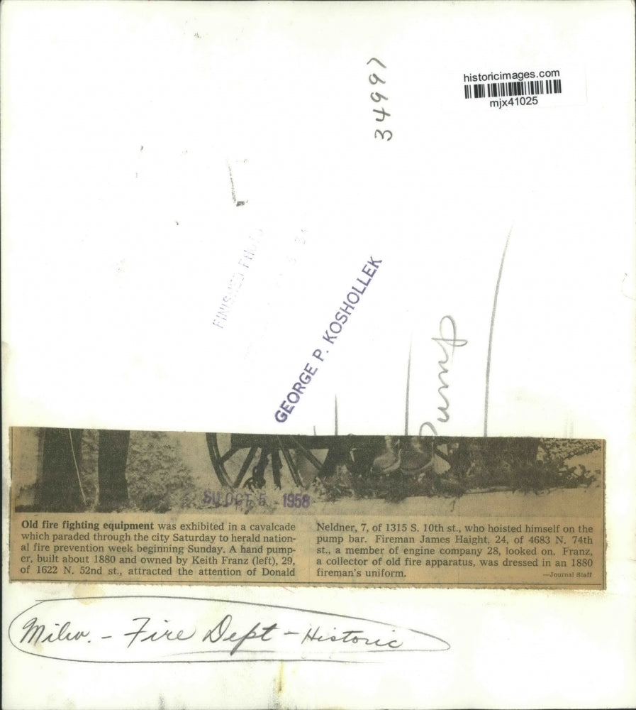 1958 Press Photo Donald Neldner hoisted himself on bar of a 1880 hand pumper.