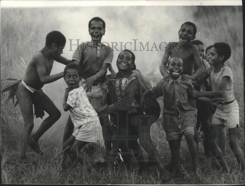 Load image into Gallery viewer, 1976 Press Photo Papua New Guinea children enjoy rough and tumble game of soccer
