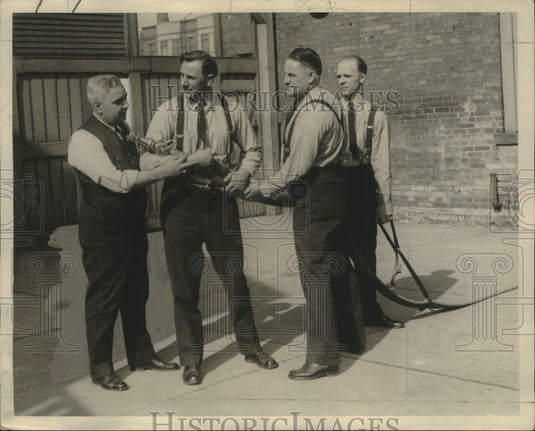 1933 Press Photo Milwaukee firefighters receive instruction on proper technique.- Historic Images