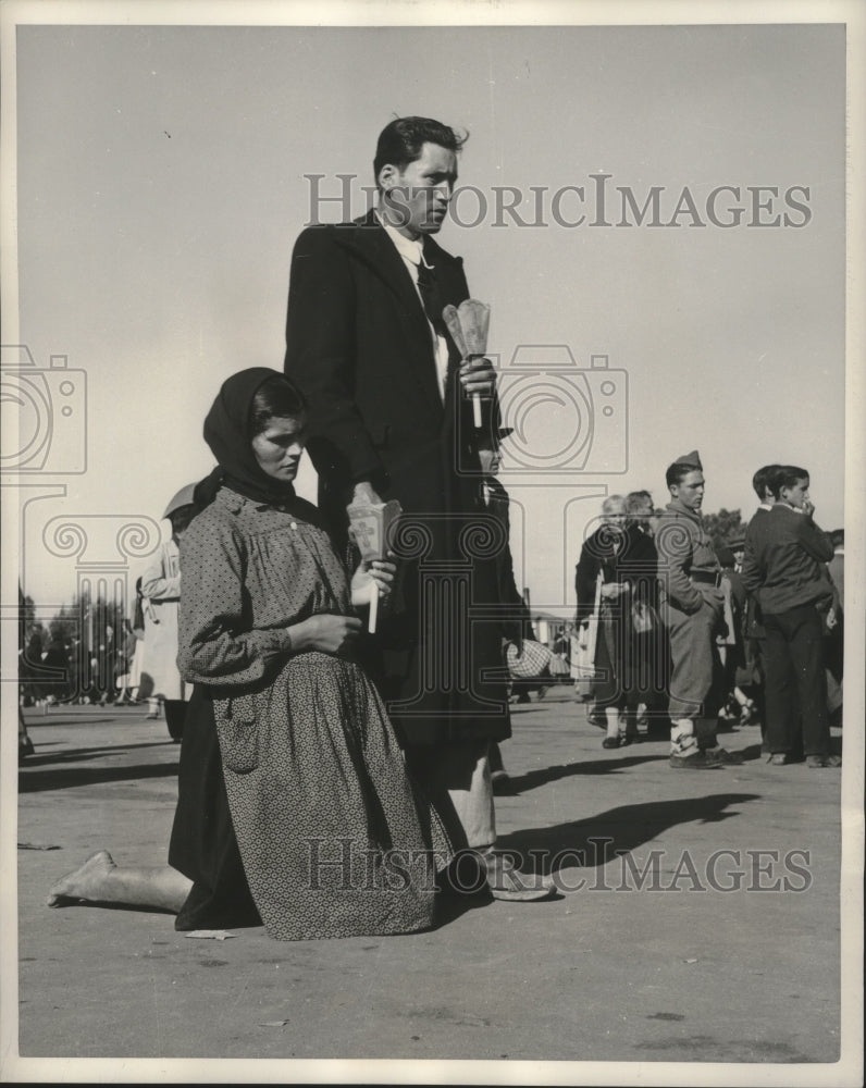 1951 Press Photo Couple in Portugal shown carrying candles during pilgrimage.- Historic Images