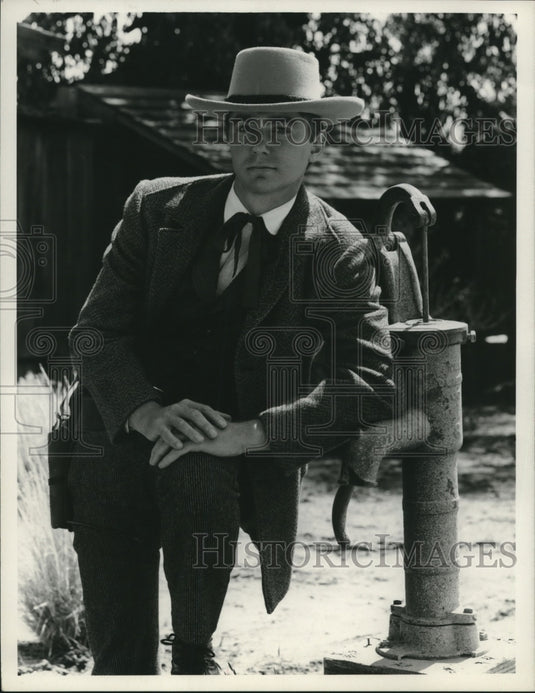 1968 Press Photo Randy Boone leaning on water pump in "Cimarron Strip"- Historic Images