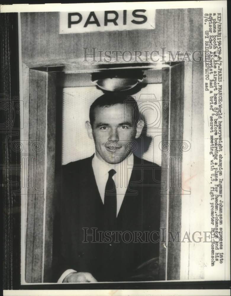 1956 Press Photo Ingemar Johansson squeezes into phone at airport in France.- Historic Images