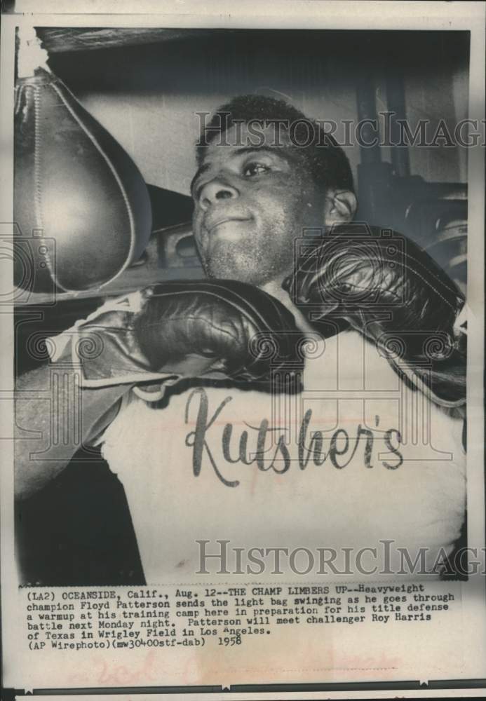 1958 Press Photo Heavyweight Floyd Patterson limbers up at training camp.- Historic Images