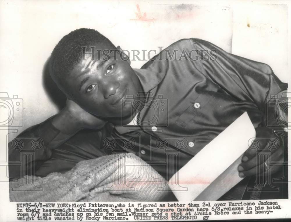 1956 Press Photo Boxer Floyd Patterson relaxing in his hotel room, New York- Historic Images