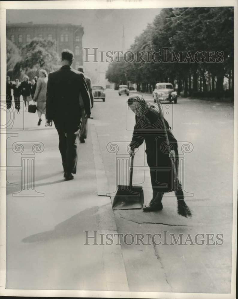 1958 Press Photo Latvia woman cleans street by hand with broom, Riga - mjx89792