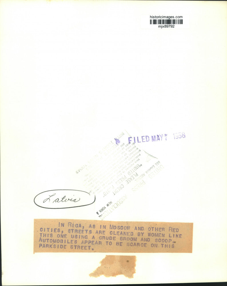 1958 Press Photo Latvia woman cleans street by hand with broom, Riga - mjx89792