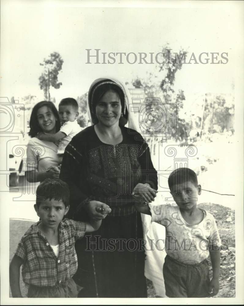 Load image into Gallery viewer, 1968 Press Photo Arab mothers &amp; children leave a Kupat Holim clinic in Israel.
