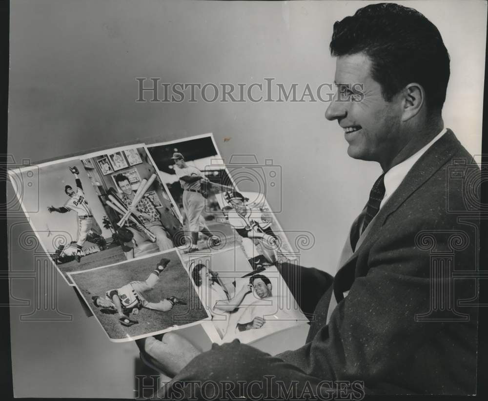 1957 Press Photo Andy Pafko of Milwaukee Braves looked over some pictures.- Historic Images