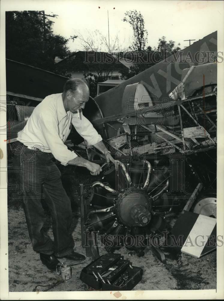 1957 Press Photo Provolt repairs rotary engine for French Le Rhone - mjx97728- Historic Images