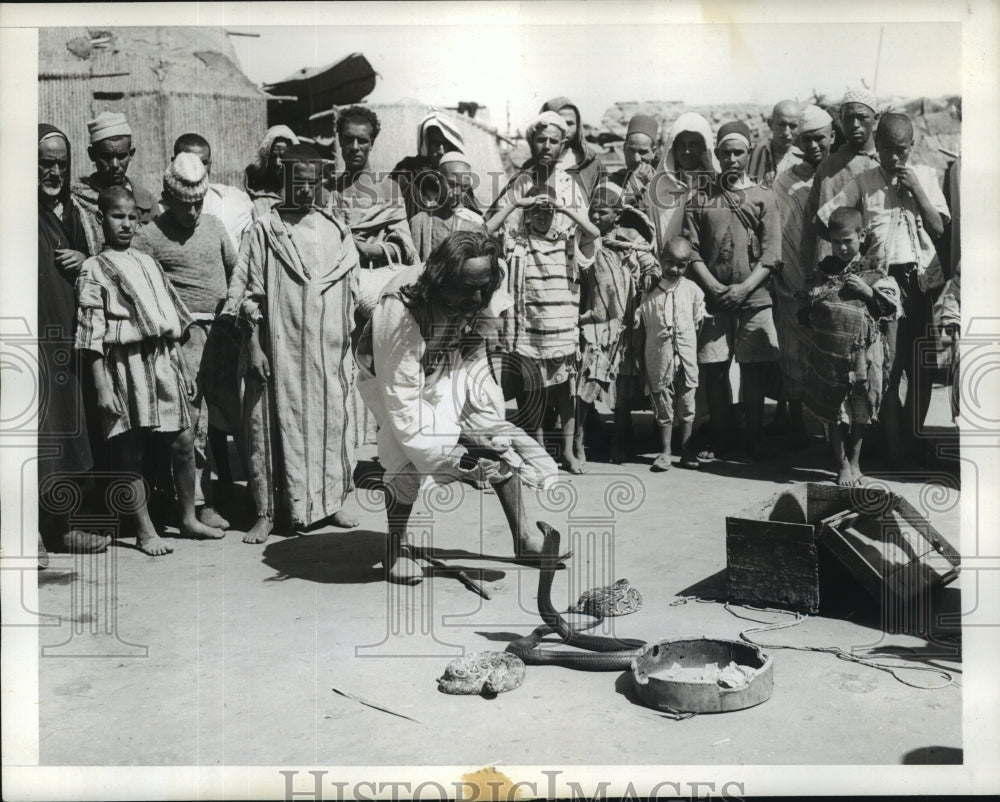 1943 Press Photo Snake charmer coaxes cobra at Marrakech Market Place, Morocco- Historic Images