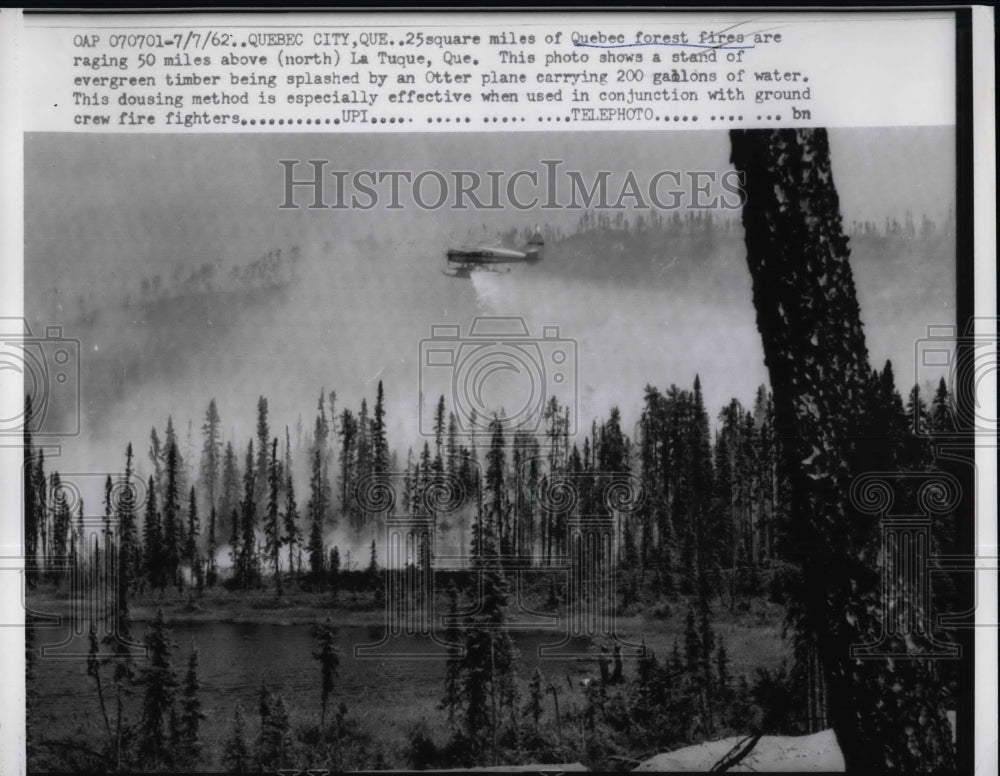 1962 Press Photo View Of Flying Aircraft Equipped With Special Spraying Water