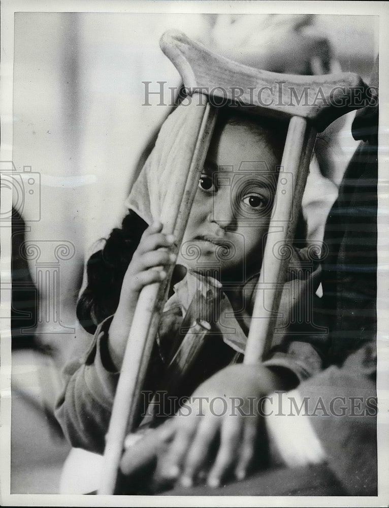 Load image into Gallery viewer, 1962 Press Photo Malika Doiss looking through her crutch in Morocco rehab center
