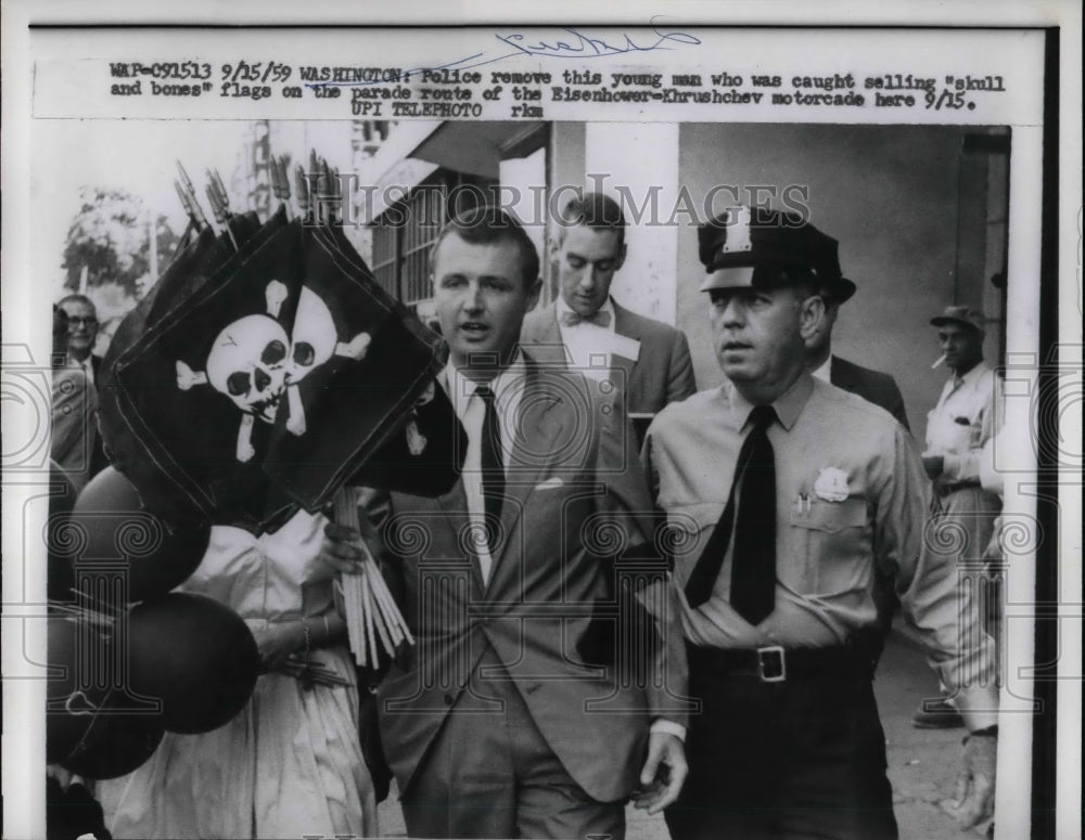 1959 Press Photo Police with man caught selling skill and bones flags