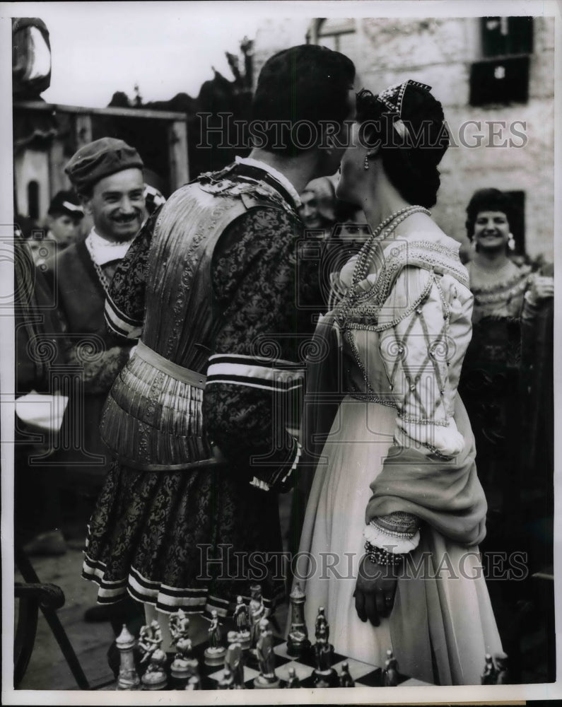 Load image into Gallery viewer, 1955 Press Photo After winning the game a knight kissed his Bride to be.
