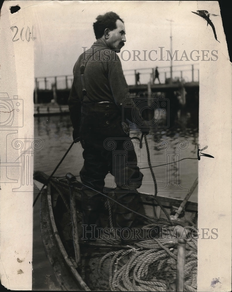 Load image into Gallery viewer, 1923 Press Photo A man on his coastal fishing boat - nea84652
