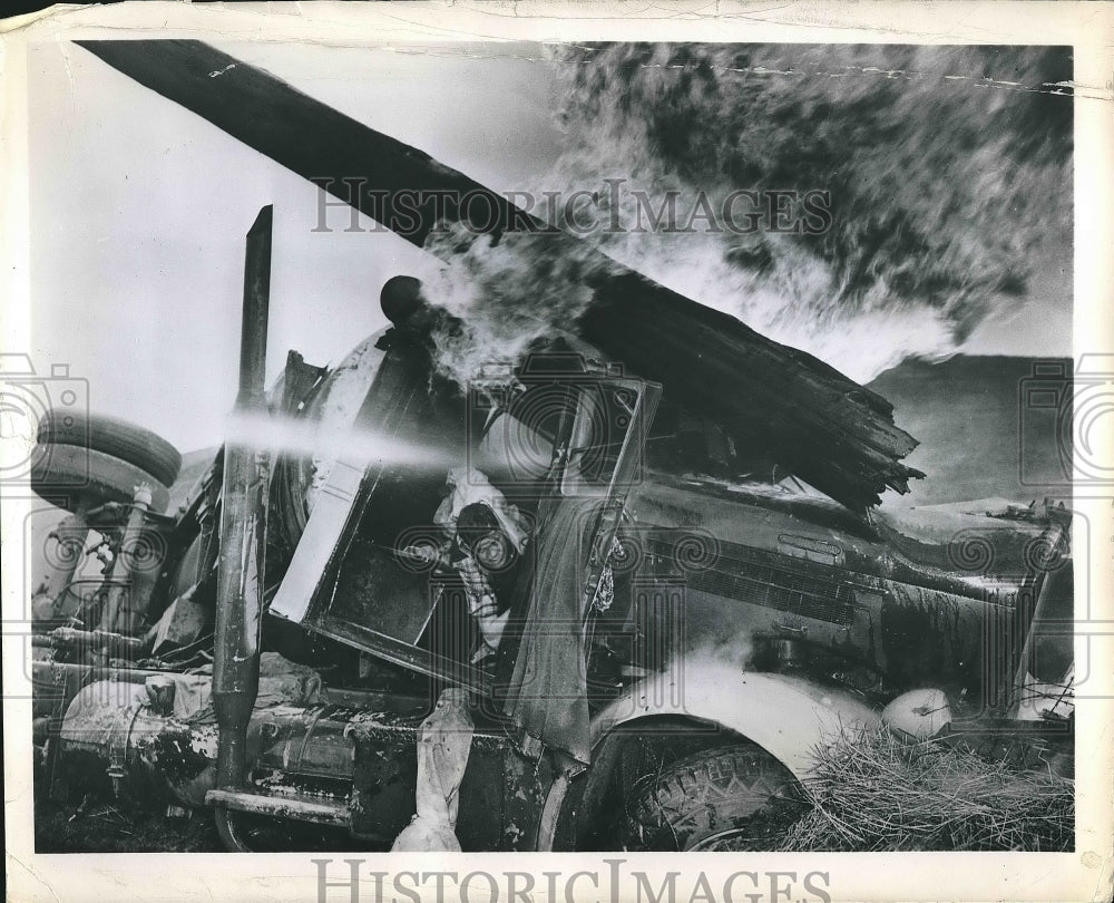 1950 Press Photo A driver pinned in a truck that is on fire - nea88633