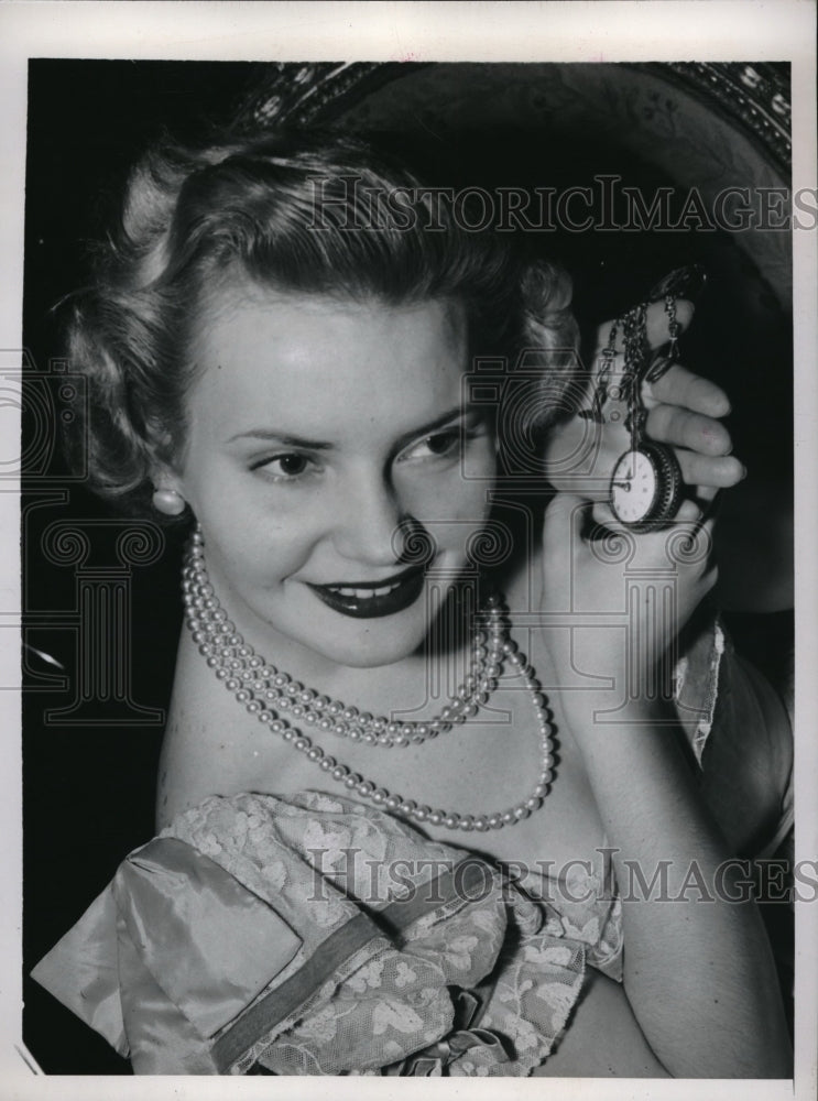 Load image into Gallery viewer, 1948 Press Photo Elaine Aiken listening to watch at New York Antiques Fair
