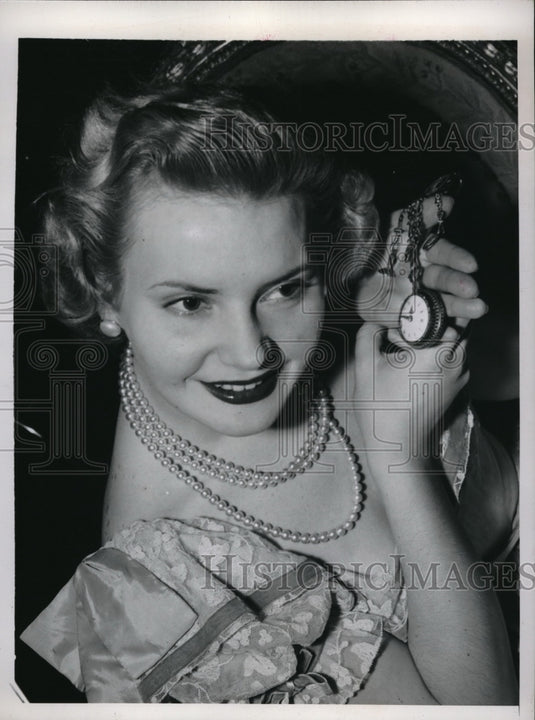 1948 Press Photo Elaine Aiken listening to watch at New York Antiques Fair