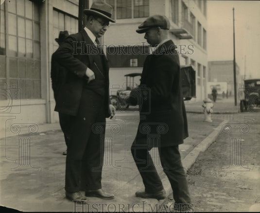 1925 Press Photo Two men on a street corner in front of some autos- Historic Images