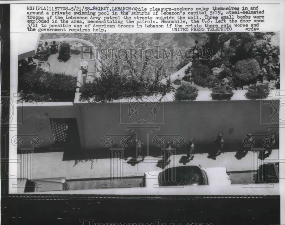 1958 Press Photo Troops outside of Lebanese capital while people are swimming