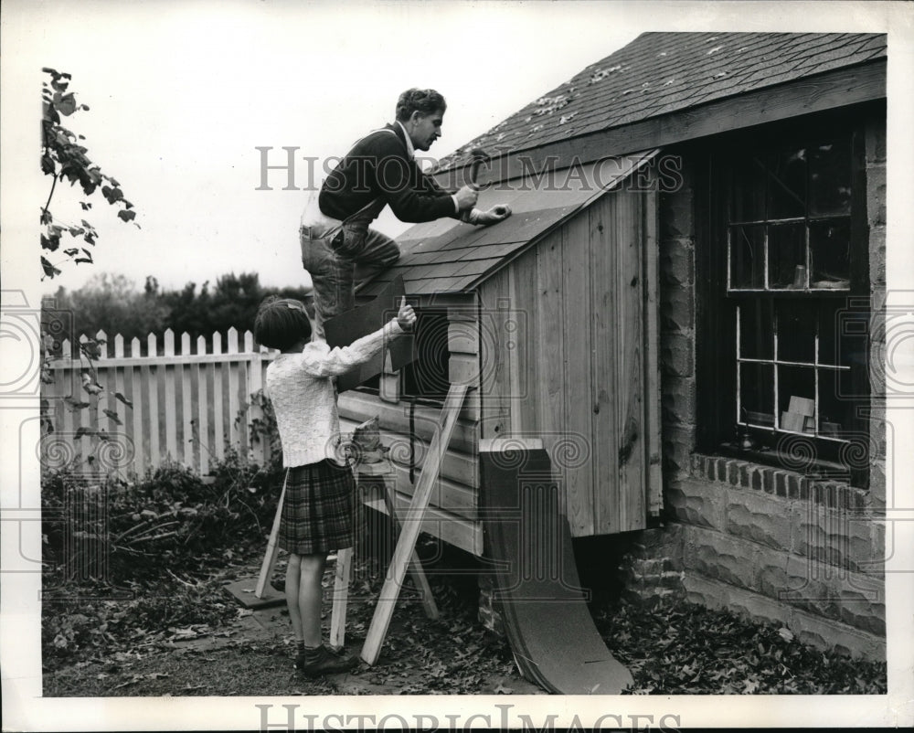 1943 Press Photo Anne, 9, helps her dad put the shingles on after school- Historic Images