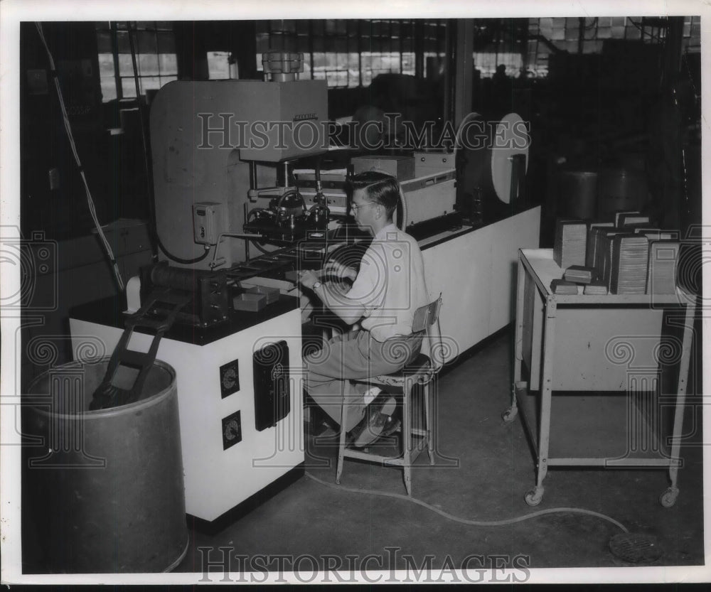 1954 Press Photo Worker Using Metal Stampers at B.F. Goodrich Chemical Co.- Historic Images