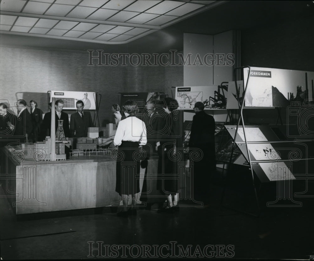 1957 Press Photo Visitors study Marshall plan display at Amerika house in Essen- Historic Images