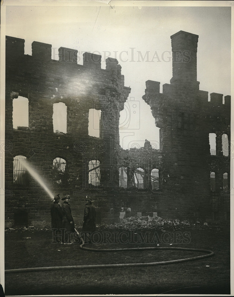 1931 Press Photo Firemen spray water on fire damaged building