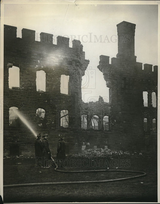 1931 Press Photo Firemen spray water on fire damaged building