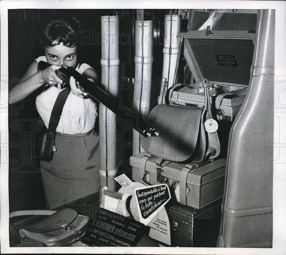 1955 Press Photo Paris woman trying out Double barreled shotgun in Paris Store- Historic Images