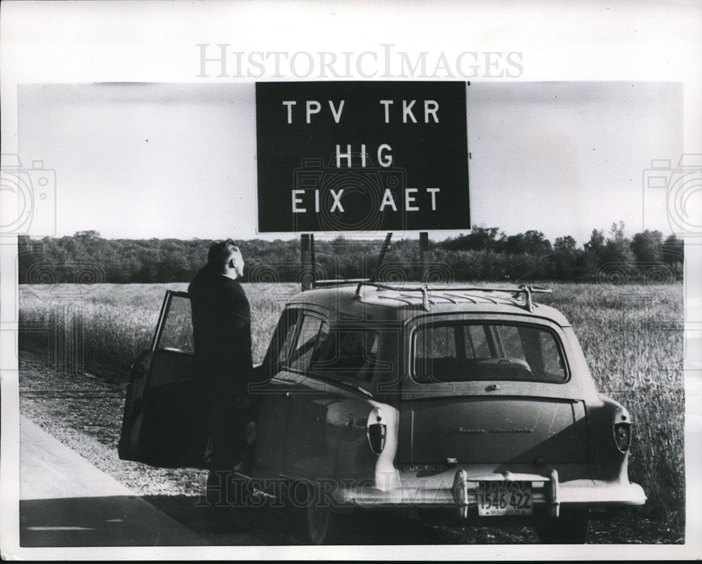 1956 Press Photo Puzzled motorist looks at sign part of series of visual test - Historic Images