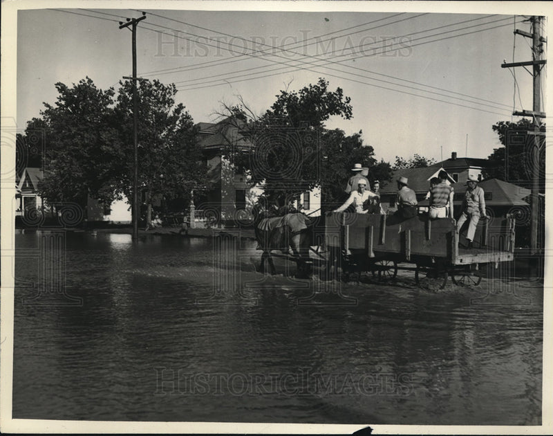 Load image into Gallery viewer, 1938 Press Photo men riding in horse drawn wagon thru flooded Kansas town
