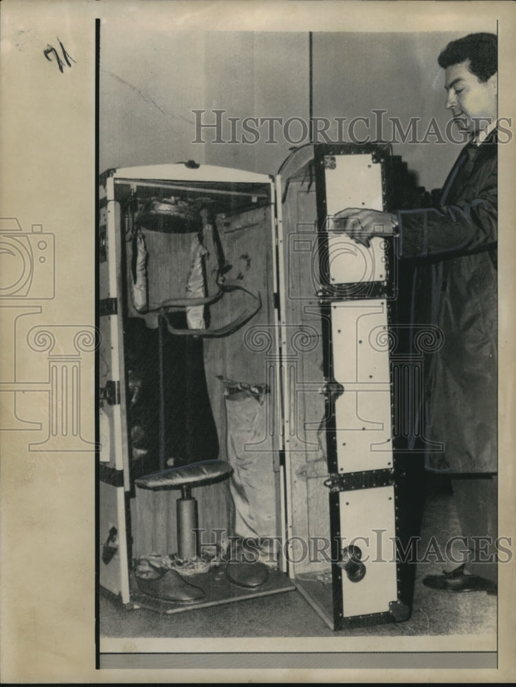 Press Photo Man opening a chest
