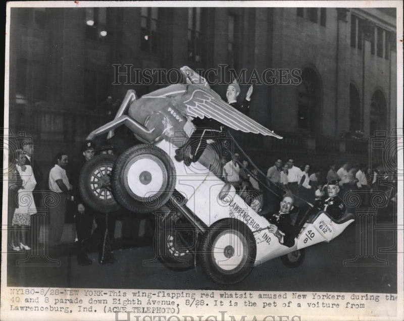 Load image into Gallery viewer, 1948 Press Photo Winged float car in parade in NYC on Eighth Ave
