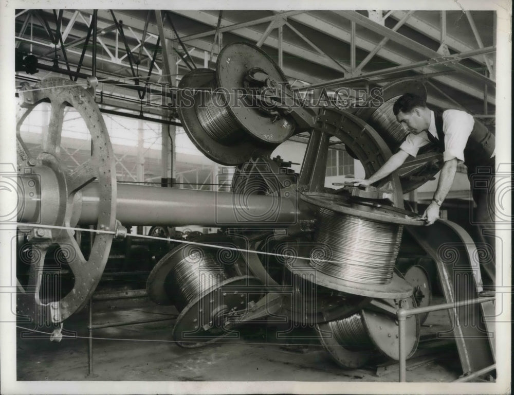 1936 Press Photo Norman Smith , at General Cable Co with spools of wire- Historic Images